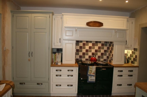 Overmantle with AGA below, larder unit to the left hand painted in a different colour.