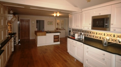 Cream Kitchen With Contrasting Wooden Floor